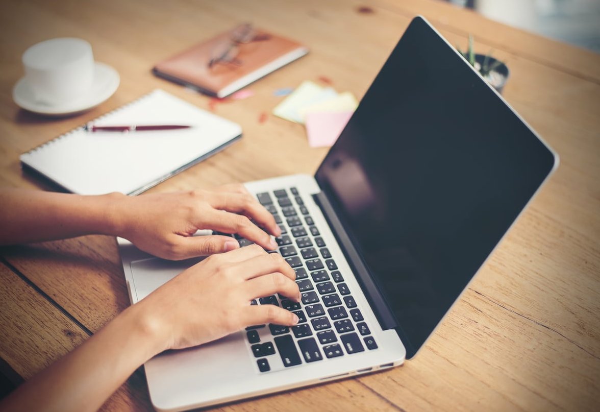 journalist typing laptop