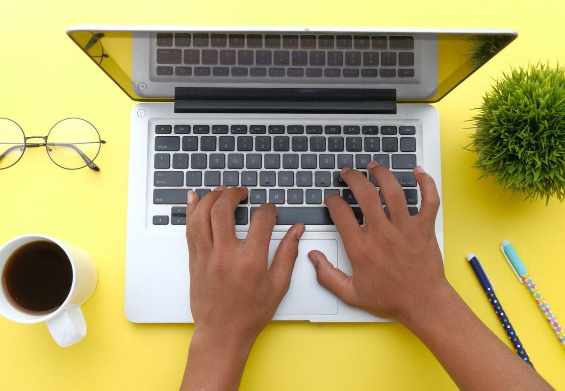 journalist typing laptop
